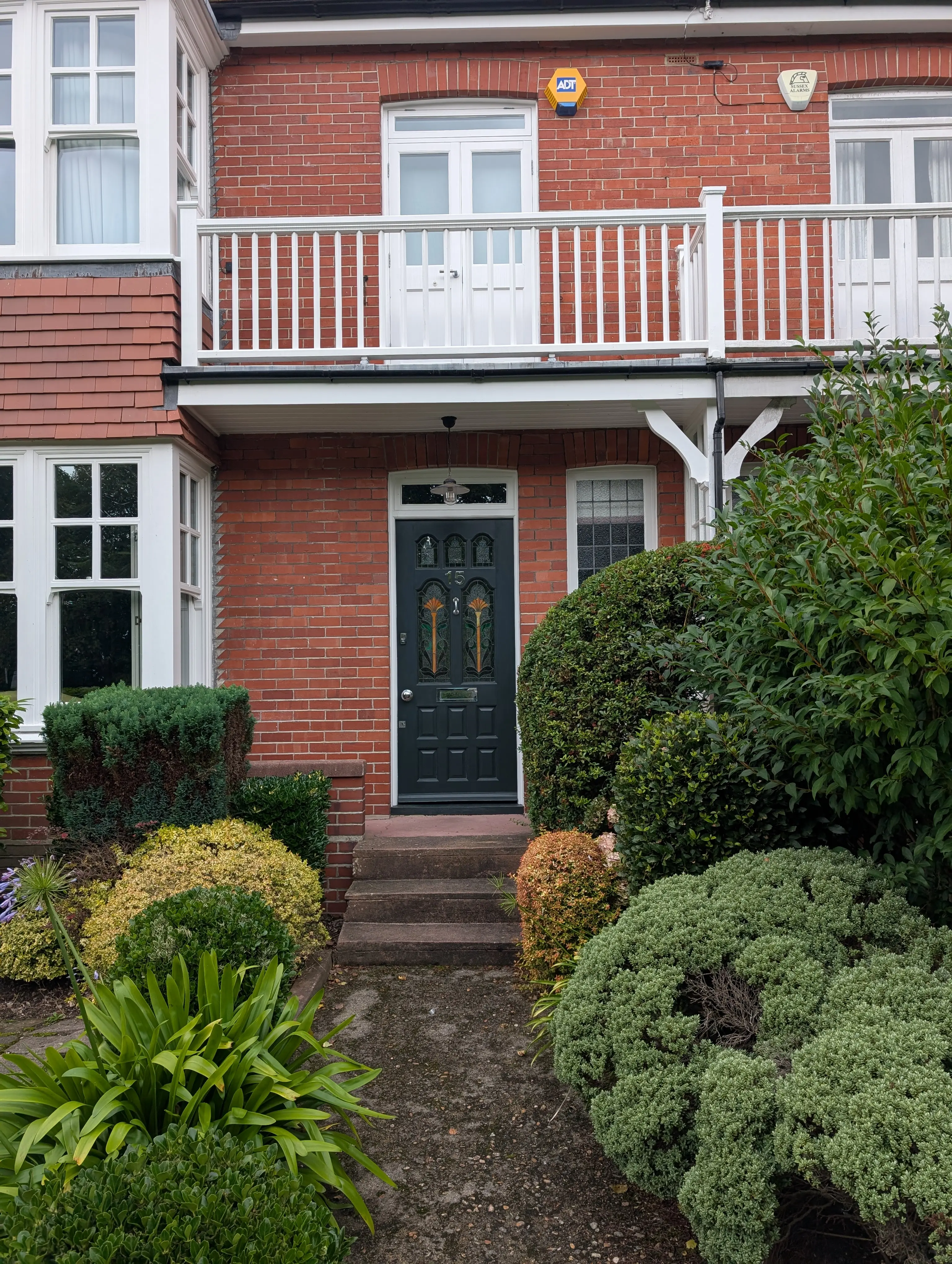 black door on red brick building ornate windows