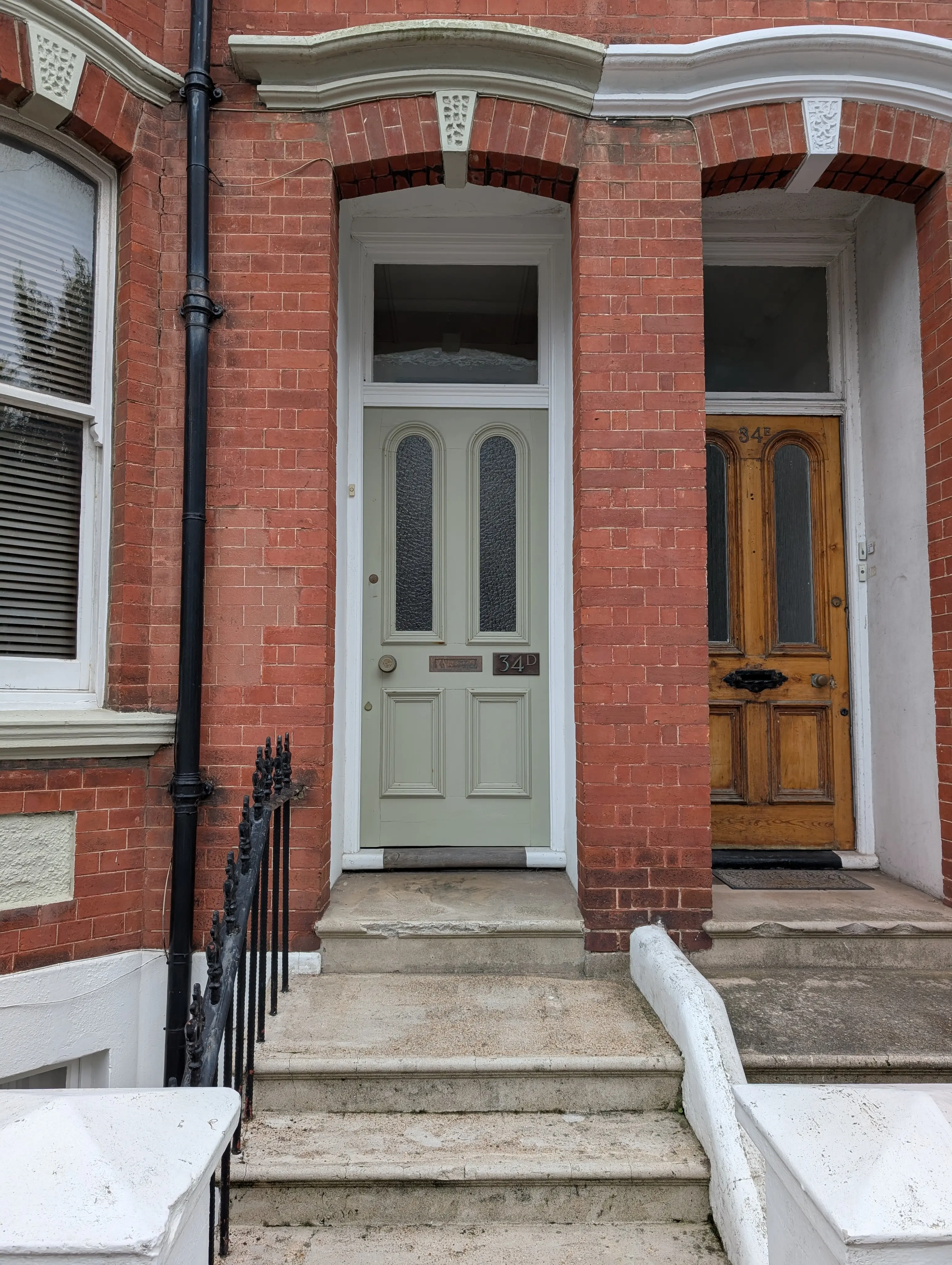 pastel green door on red brick building