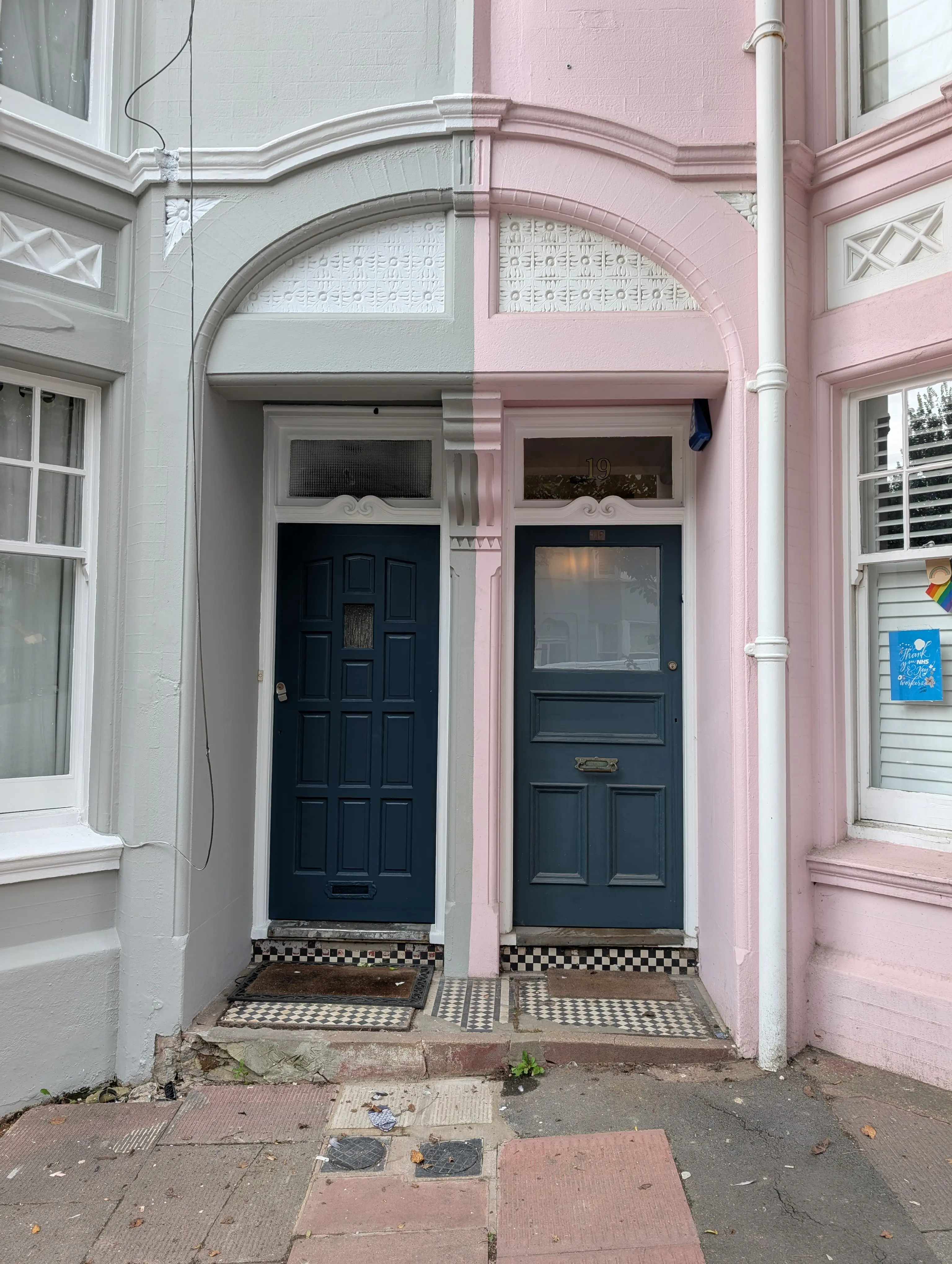 pair of doors left building is gray right building is pink