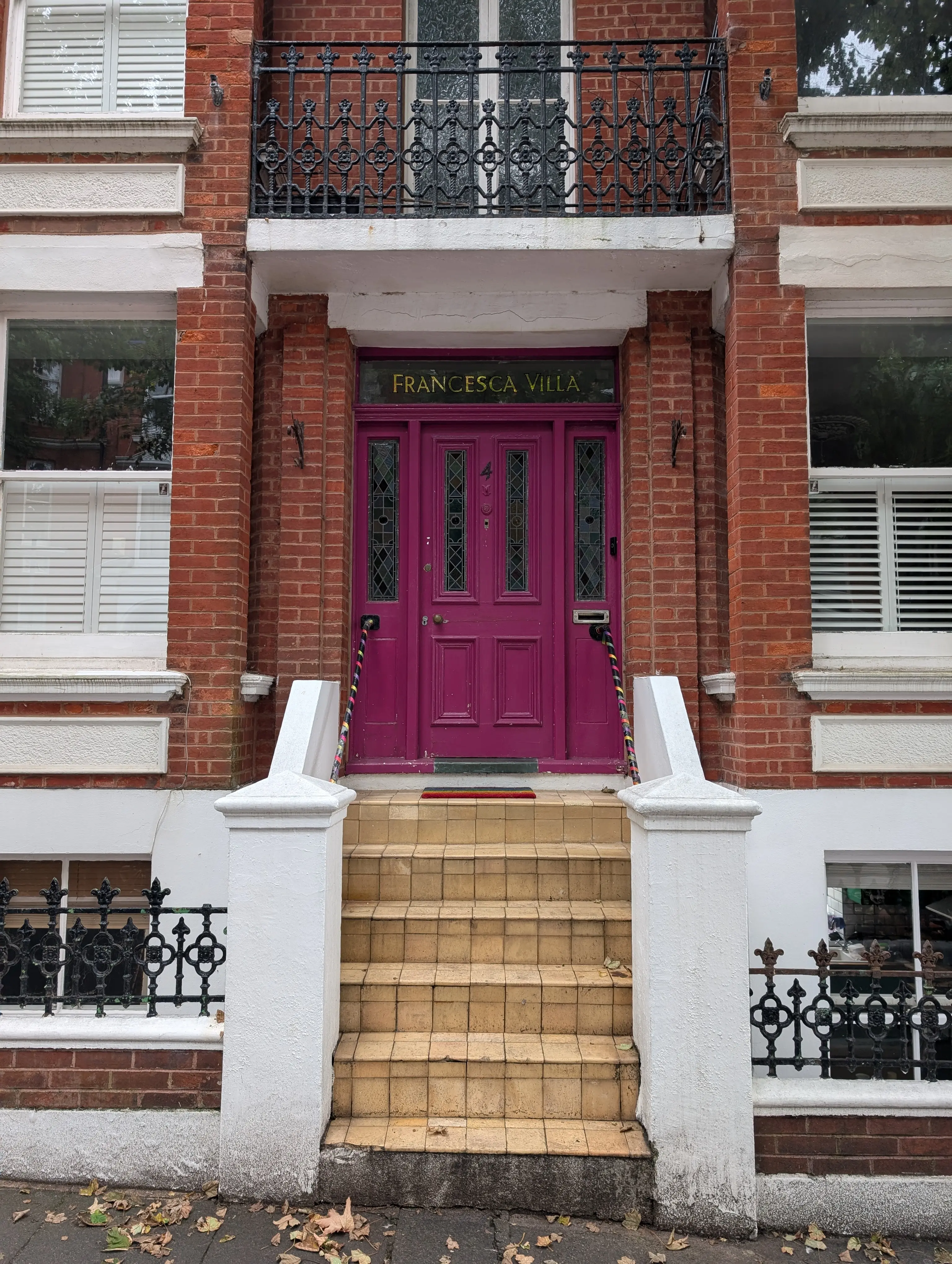 pink door with gold lettering above the door