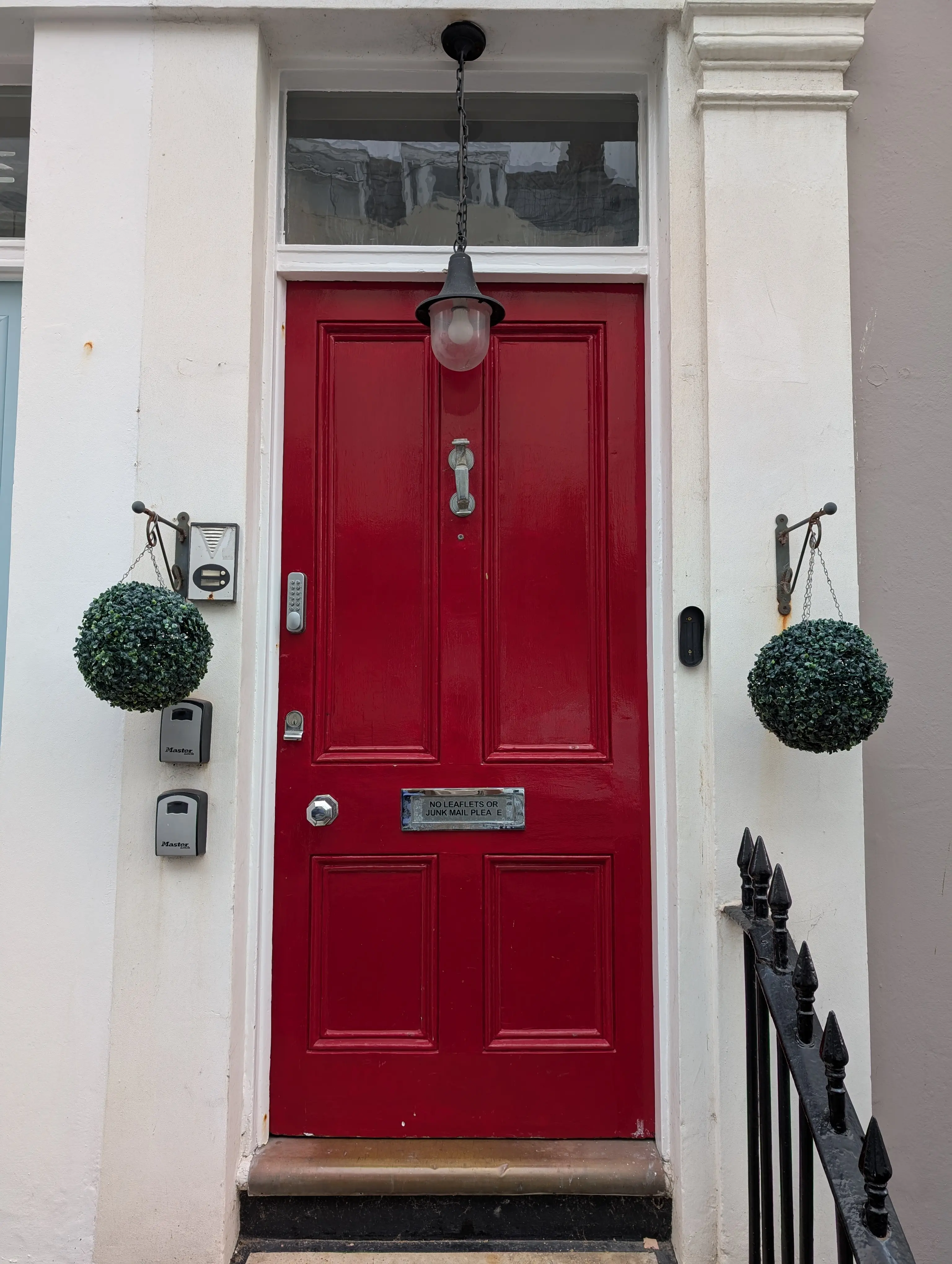 red door with large lamp hanging above