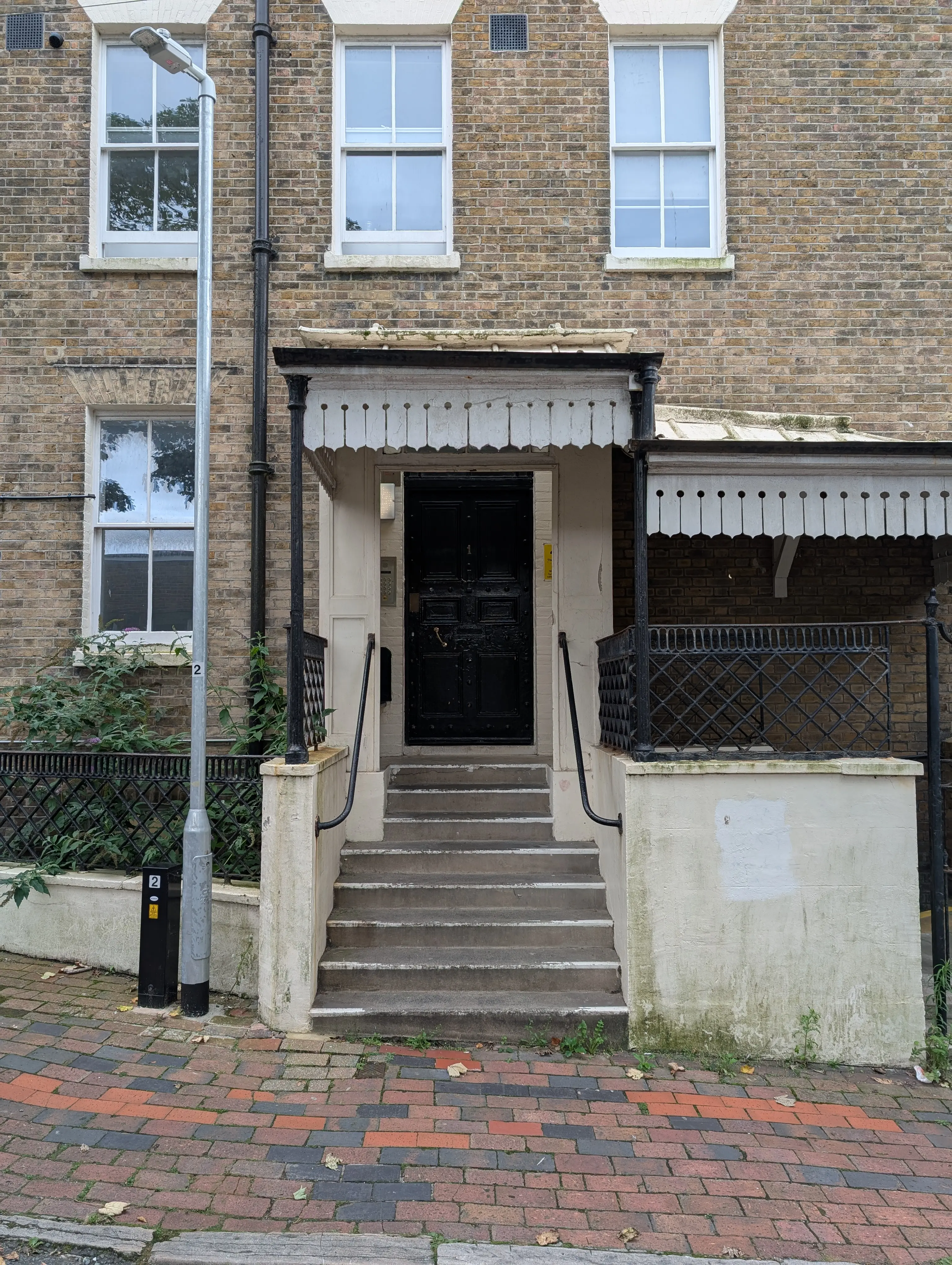 old heavy black door with ornate porch roof