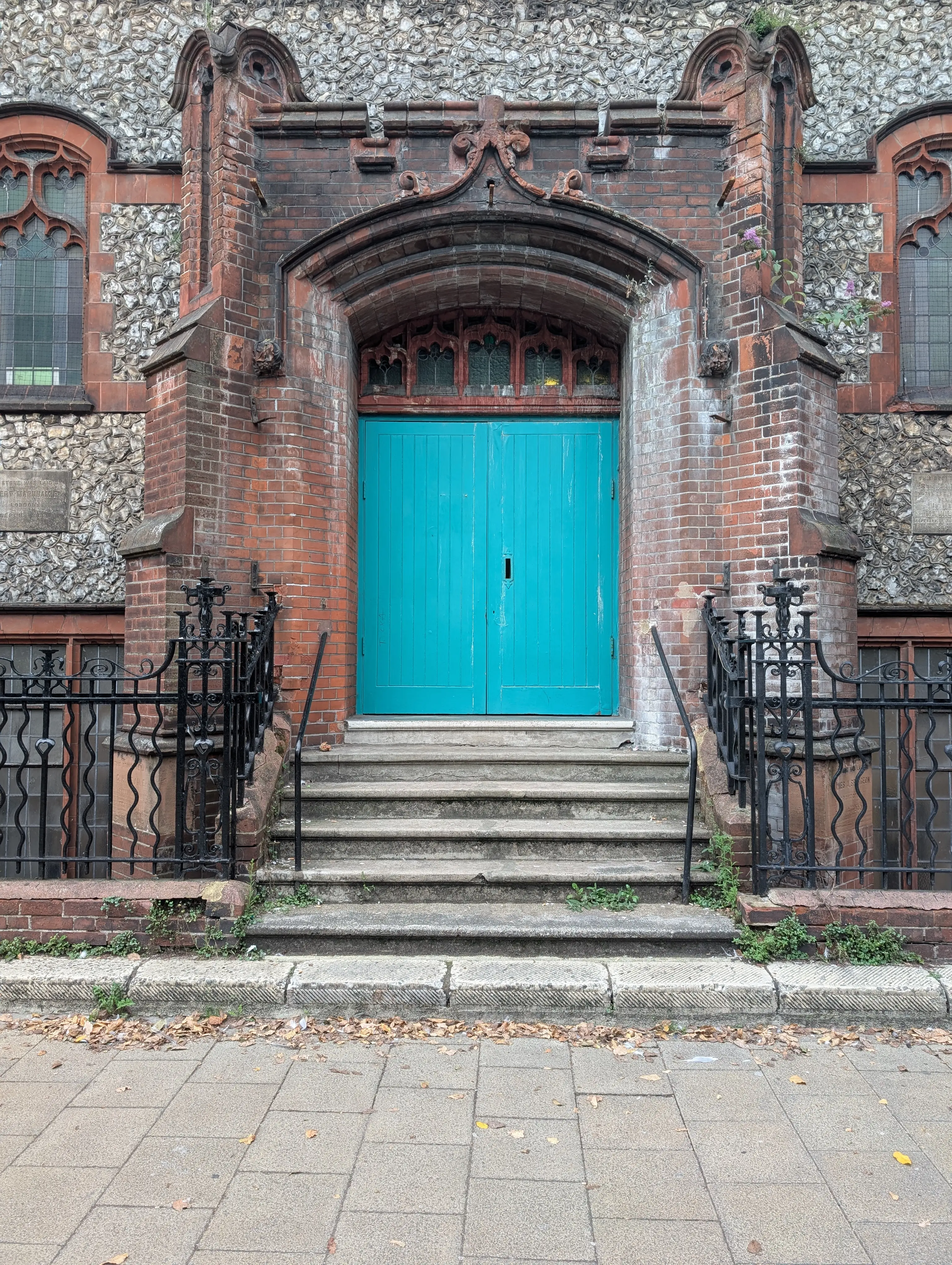 large bright blue church doors at the top of a set of stairs